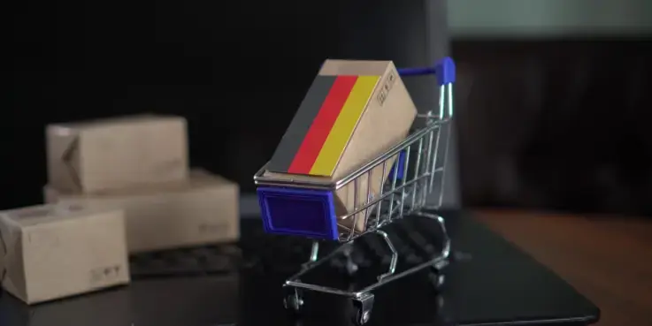 Een winkelwagentje met een Duitse vlag erin. Tips voor verkopen in Duitsland